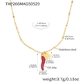 Detailed macro view of 18k gold plated red chili and four-leaf clover pendant charms - Necklace / Gold
