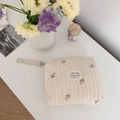 Close-up of quilted cotton baby bag with delicate tulip embroidery and wristlet - Tulip Style