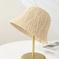 Beige openwork knit bucket hat with textured crochet pattern on gold metal stand - One Size Adjustable / Light Khaki