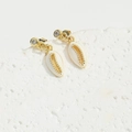 Detailed close-up of shell-shaped gold earrings with rhinestones on a textured stone - White Shell