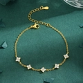 Elegant gold flower bracelet with micro-p镶 zircon stones on green textured background - Gold