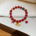 Macro detail of red beaded horse bracelet with gold accents and zircon charms - Vintage Rocking Horse Style