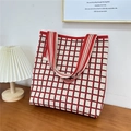 Detail of red and white checkered knit tote bag on wooden table with a cozy lamp - 9 3D Grid Red Beige