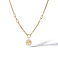Macro detail of golden Tree of Life pendant with white cubic zirconia and mixed chain links - Gold