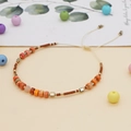 Handmade bohemian seed bead bracelet with orange stone and adjustable cream cord - Brown/Orange