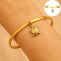 Adjustable golden stainless steel open bangle featuring a detailed sea turtle charm pendant - Turtle Pendant Open (5202)