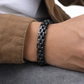 Close-up of a polished black stainless steel link bracelet worn on a man's wrist - Black 21cm Length 1.1cm Width