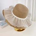 Brown straw beach hat with white lace trim and pearl chain on display stand - Khaki Pearl Mesh