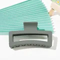 Close-up of a matte sage green rectangular hair claw clip with a secure grip design - 12cm XL Square - Forest Green