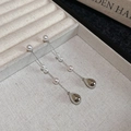 Primer plano de pendientes vintage de plata con perlas en un joyero de color beige elegante - Pendientes de Pin de Plata - Plateado - Rosa - Blanco