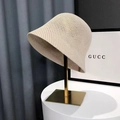 Chic cream crochet bucket hat with hollow-out knit texture on a gold stand - Honeycomb Style / Off White