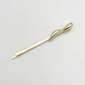 Detail view of a glossy gold irregular streamlined alloy hair clip on a neutral background - Single 1# / Gold
