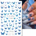 Detailed blue butterfly nail art stickers shown with realistic hand application effect - F1030 (Blue Butterfly)