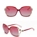 Polarized women's oversized round sunglasses in red frame with gold camellia detail - Polarized Deep Red Frame Gradient Red Lens