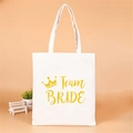 Beige canvas tote bag with gold crown and Team Bride text for bachelorette parties - Yellow Crown Team Bride
