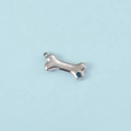 Detailed macro shot of a silver bone-shaped pendant with a sparkling blue zircon stone - Steel Color December