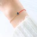 Elegant gold chain and red cord bracelet with a blue sapphire zircon stone - September Blue