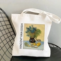 Off-white Van Gogh Irises painting print canvas tote bag on a minimalist black chair - Still Life Vase with Irises (STD525-K)