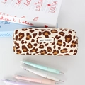 Close-up of leopard print corduroy pencil case with white zipper and brand label - Beige Large Leopard