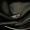 Macro view of silver star and flower ring with red gemstones on black silk fabric - Adjustable Open / Silver Flower Star Red Gem