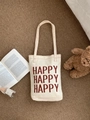 Detail der cremeweißen Canvas-Tragetasche mit rotem Happy-Aufdruck und Lifestyle-Deko - Gebrochenes Weiß