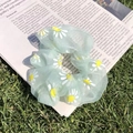 Mint green organza scrunchie with daisy pattern on a newspaper and grass background - Green Mesh Daisy