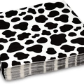 Stack of cow print paper napkins for farm animal themed birthday party decorations - 20 Napkins 33*33cm