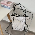 White large capacity tote bag with black bow floral pattern and shoulder straps - White