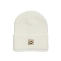 Detailed close-up of cream knit beanie featuring a minimalist square smiley face patch - White