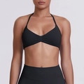 Front view of black halter neck sports bra with V-neckline and minimalist pleated details - Black
