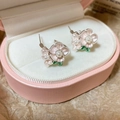 Detail of pink enamel flower earrings with pearl accents in a pink jewelry gift box - Pearl Flower Design