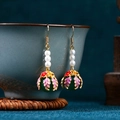 Detail view of Chinese style enamel butterfly earrings with pearls on a porcelain cup - CP987-Green Bead Enamel Leaf