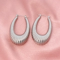 Detailed view of silver oval hoop earrings with thick croissant texture and vertical grooves - Croissant Ribbed Style (CK241) / Steel