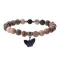 Detailed close-up of beaded bracelet featuring marble texture beads and a blue butterfly charm - Matte Pink Zebra + Blue Sand Stone