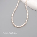 Mini 4mm freshwater rice pearl necklace with white luster on a modern gray stand - Seed Beads