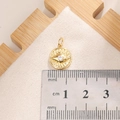 Macro shot of gold sunburst evil eye pendant with cubic zirconia and cm size ruler - E0016G
