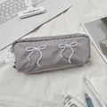 Macro detail of the gray-purple fabric pencil case with white bow embroidery and zipper - Gray
