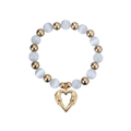 Detailed view of beaded bracelet featuring glossy cat eye stones and heart pendant - Gold/Creamy White Cat's Eye