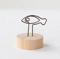 Minimalist fish-shaped wire memo clip with a natural round wooden base stand - Fish