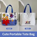 White canvas handbag with blue handles and orange cartoon monster print, front and back view - Colorful Monster-White