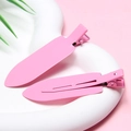 Close-up of pink matte metal hair clips on a white curved stand with floral accents - Rose Red - Glossy without Letters
