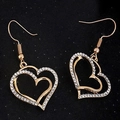 Macro shot of gold double heart earrings with crystal pavé on black background - Ear Drops Pair / Gold