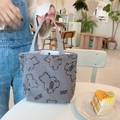 Close-up of a grey corduroy tote bag featuring a cute bear pattern in a cafe setting - Baby Bear Grey