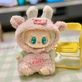 Pink plush pig onesie outfit for Labubu doll sitting with tiny yellow folding chair - Cloud-shaped Plush Pig Set / First And Second Generation Keychains Are Compatible With La Cloth Dolls. Dolls Not Included.