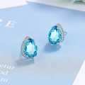 Detailed view of pear-cut blue zircon earrings with silver textured bezel settings - Sea Blue Zirconia