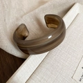 Detail view of the amber resin wide open bracelet with smooth texture and natural patterns - 51# Bracelet-Amber Translucent Open