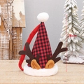 Christmas plaid hat with reindeer antlers and white pom-pom on wooden table - Red and Black Grid Reindeer Antlers