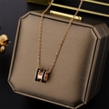 Close-up of gold-plated O-chain necklace featuring a black enamel H-shaped pendant - Pop H Style (8803) / Black