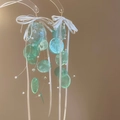 Detail von Muschel-Quastenohrringen mit grünen Blütenblättern und weißen Schleifen - 27# Lila Schleife Perle Muschel Quasten Ohrhaken
