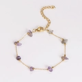 Detail view of a gold-plated stainless steel bracelet with natural purple crystal stones - Bracelet